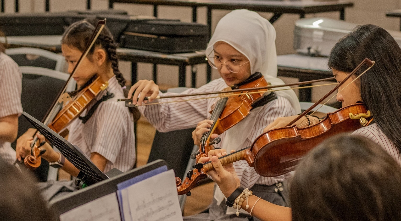 Students play violin during Music lessons